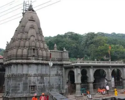 Stone temple architecture in the Sahyadri hills, representing the Bhimashankar Jyotirlinga darshan leg from Pune
